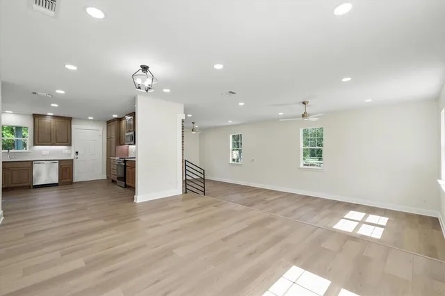 a view of a large kitchen with a sink and a window