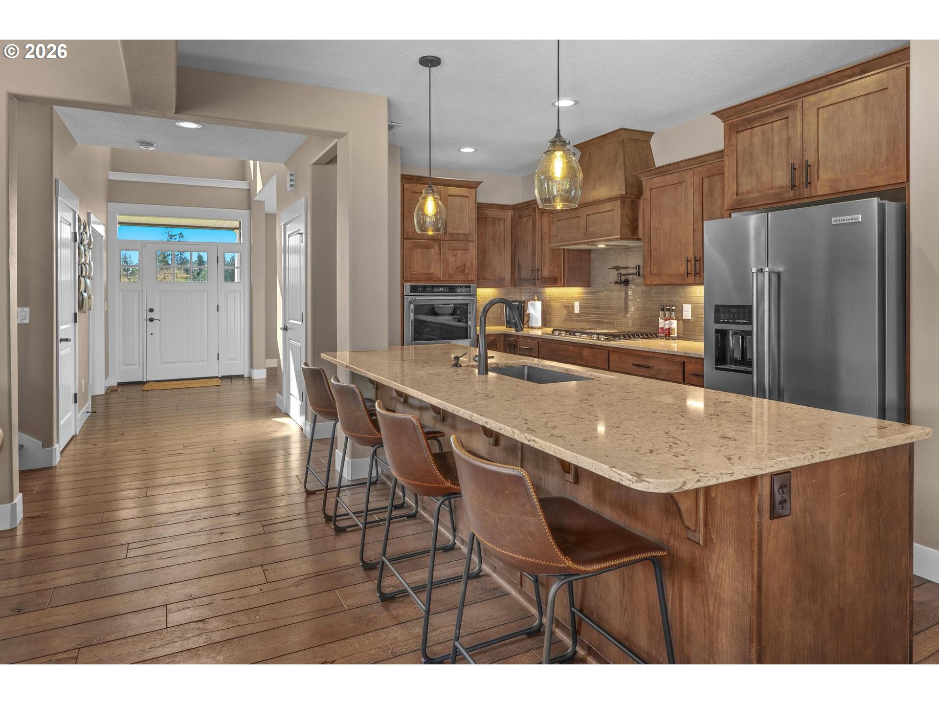 34281 Millard Road Warren, OR 97053 - Photo 12 of 47 a kitchen with stainless steel appliances granite countertop a table chairs and a refrigerator