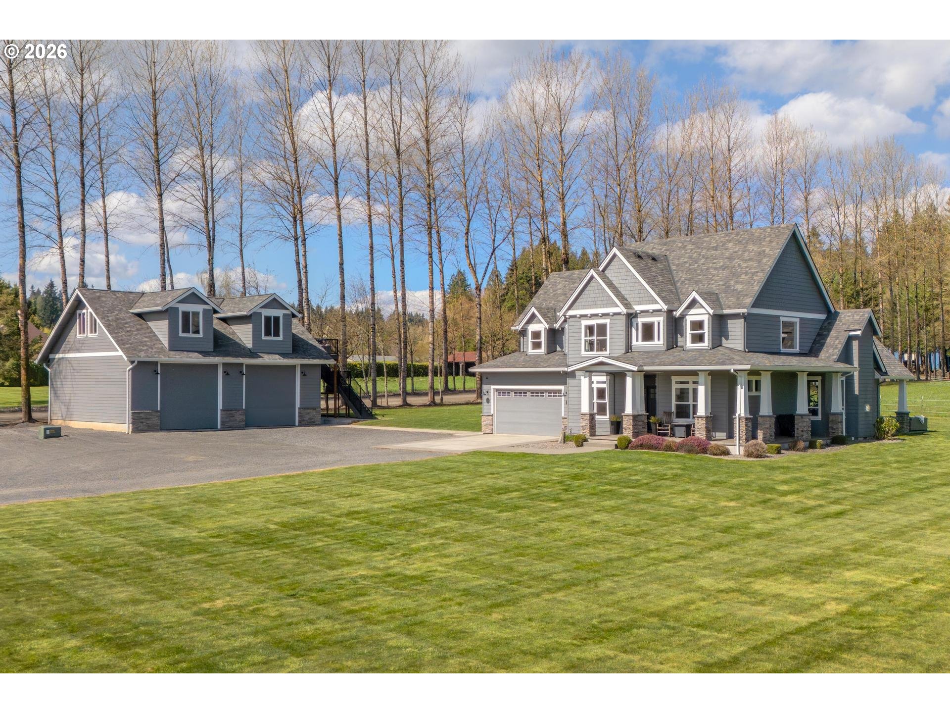 34281 Millard Road Warren, OR 97053 - Photo 2 of 47 a view of a house with a big yard and large trees