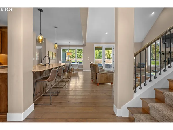 a living room with furniture wooden floor and a dining table