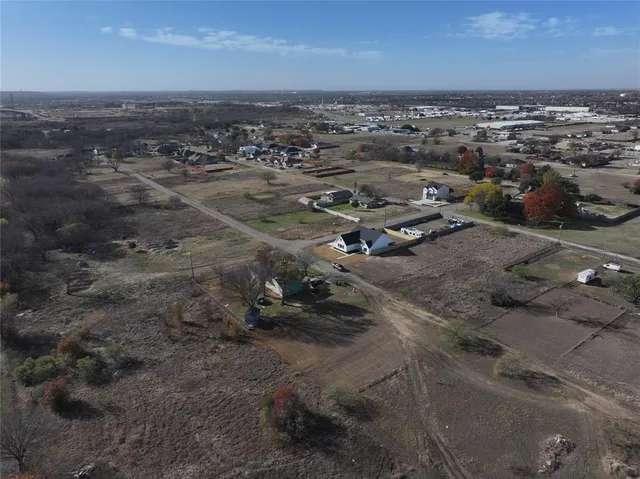 a view of dirt road with a building in the background