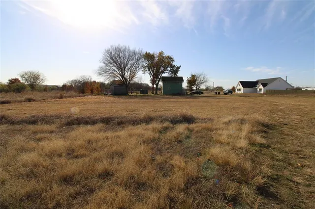 an aerial view of a houses with a yard