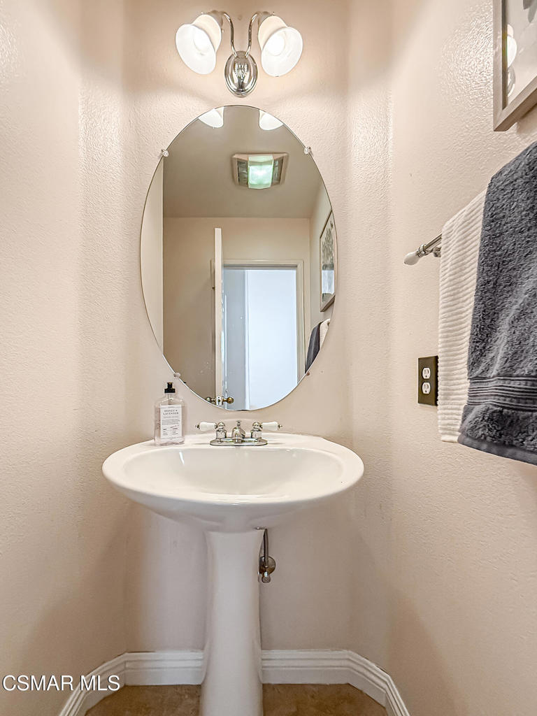 4030 Villamonte Court Camarillo, CA 93010 - Photo 17 of 42 a bathroom with a sink a mirror and a light fixture