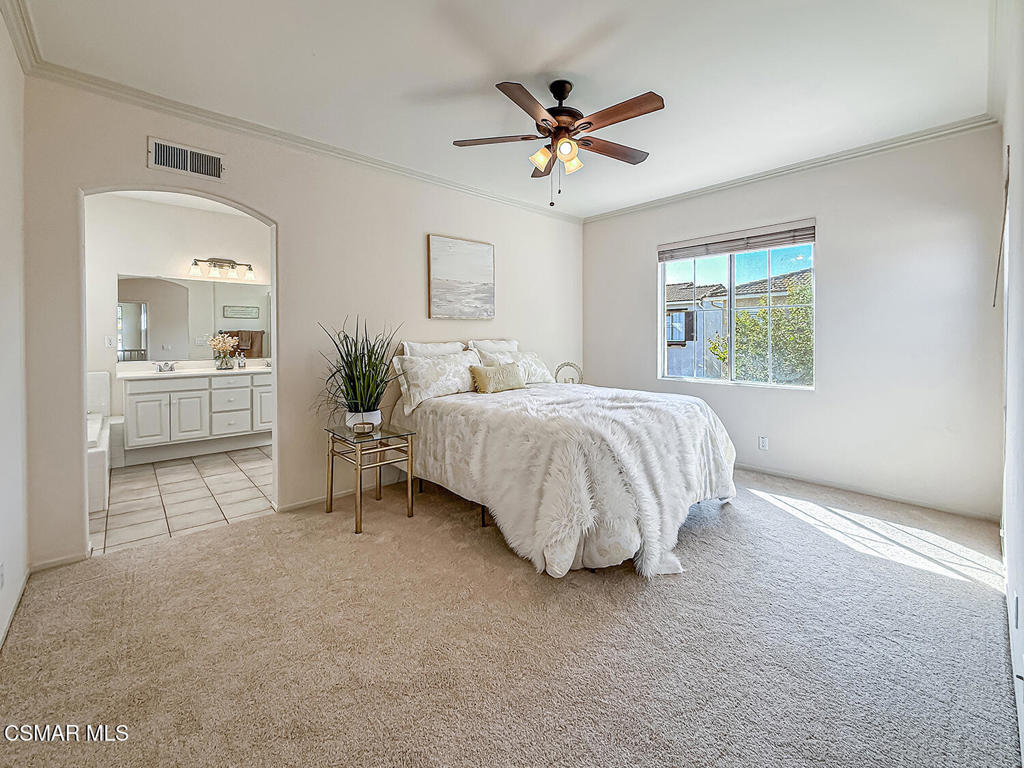 4030 Villamonte Court Camarillo, CA 93010 - Photo 26 of 42 a bedroom with a bed and a chandelier