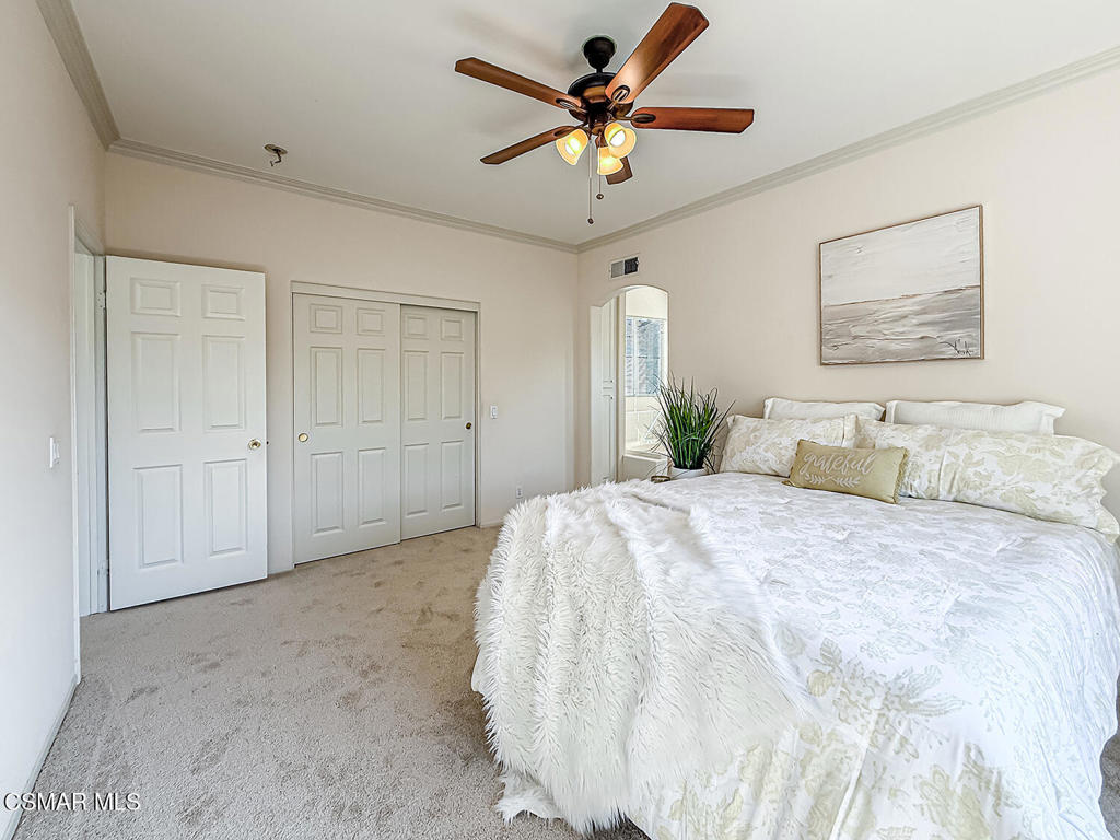 4030 Villamonte Court Camarillo, CA 93010 - Photo 27 of 42 a spacious bedroom with a bed and a ceiling fan