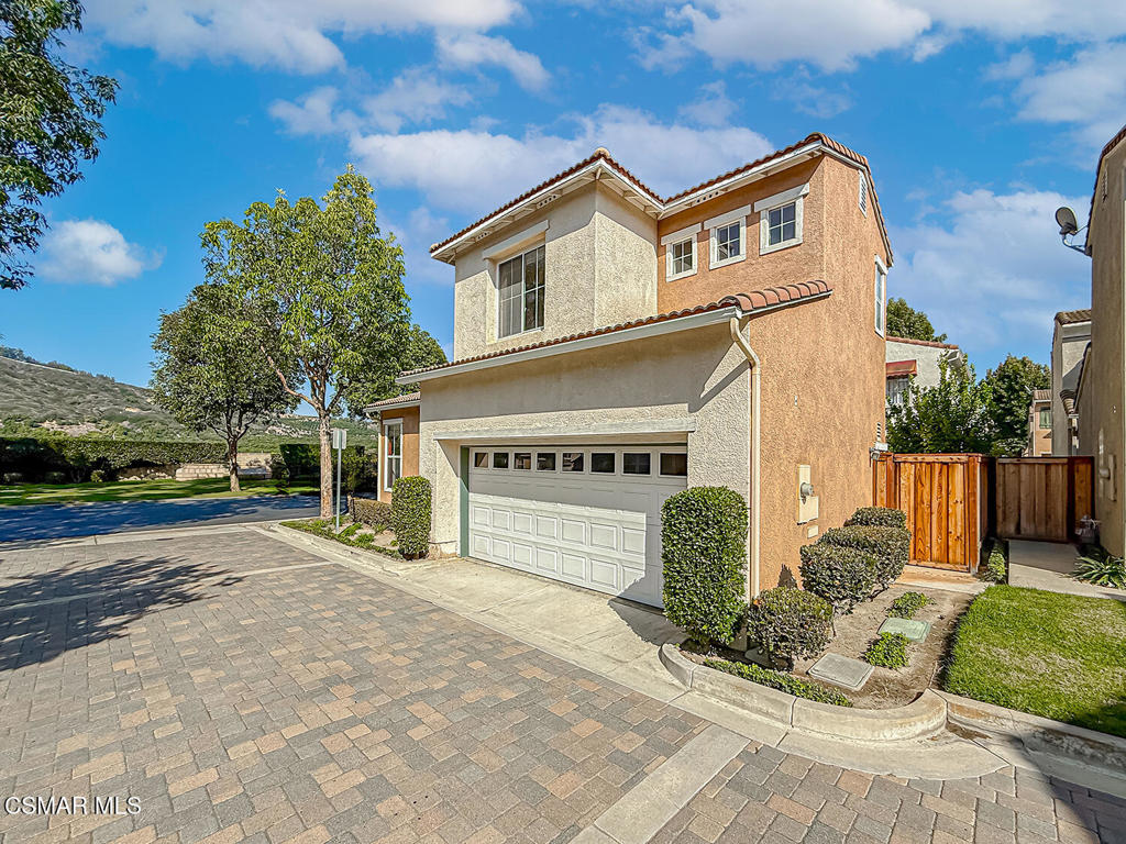 4030 Villamonte Court Camarillo, CA 93010 - Photo 4 of 42 a front view of a house with a yard and garage