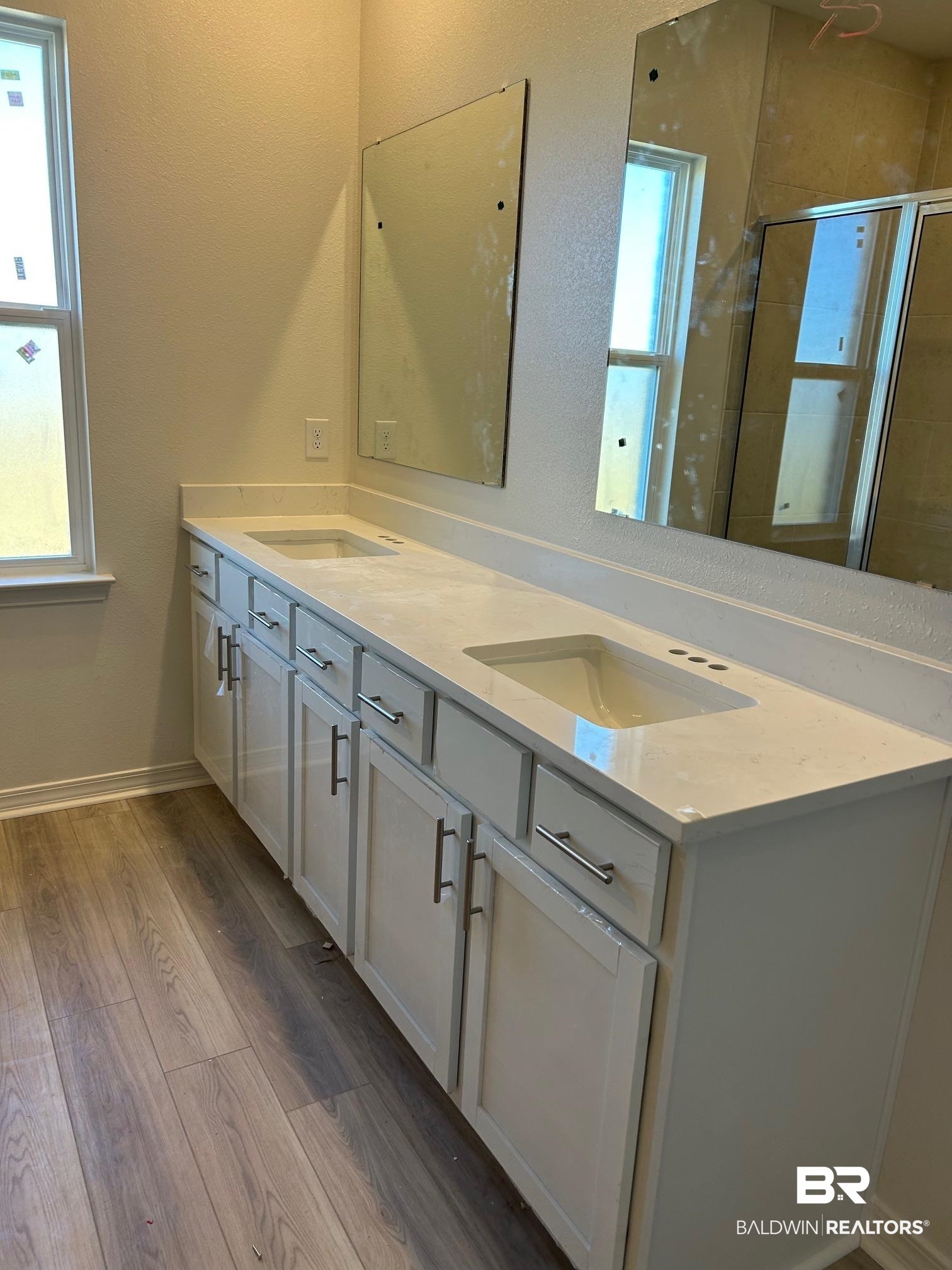 18127 Kent Circle Foley, AL 36535 - Photo 5 of 8 Full bath with double vanity, light wood-style floors, and a shower stall