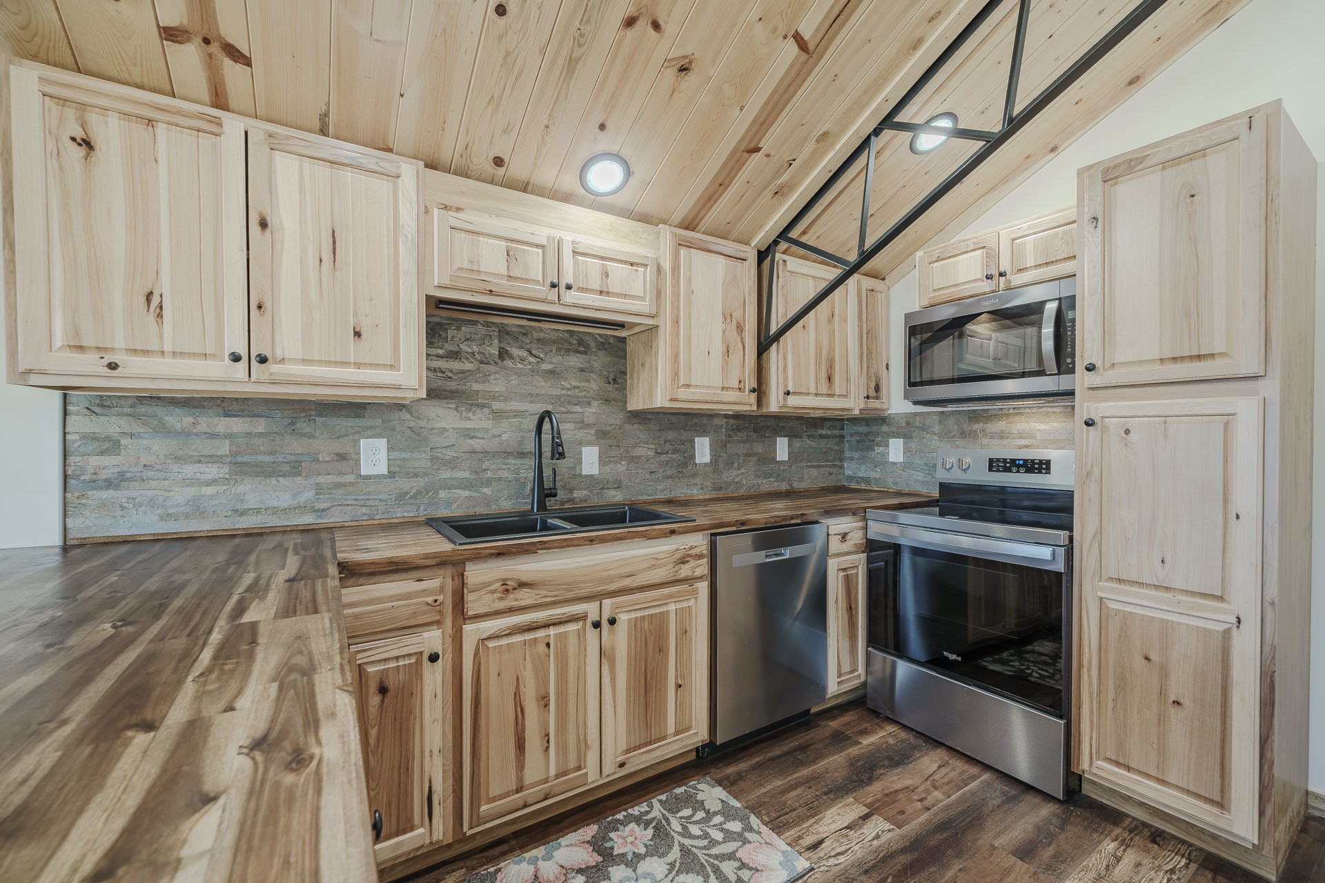 1082 WC PICKETT Road Clifton, TN 38425 - Photo 18 of 75 a kitchen with stainless steel appliances granite countertop a stove and white cabinets