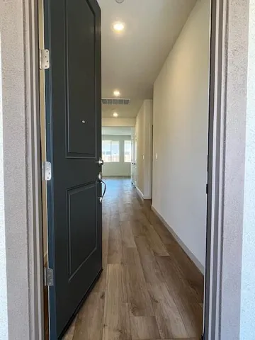 a view of hallway with wooden floor