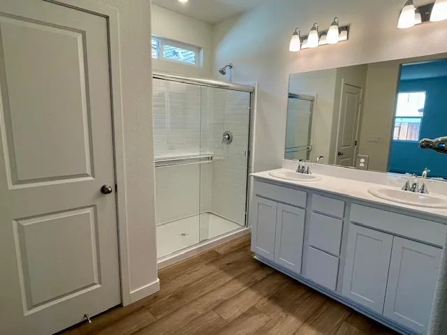 a bathroom with a double vanity sink and mirror