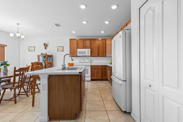 a kitchen with kitchen island granite countertop a sink counter top space and appliances