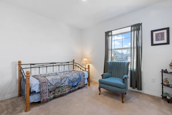 a bedroom with furniture and a window