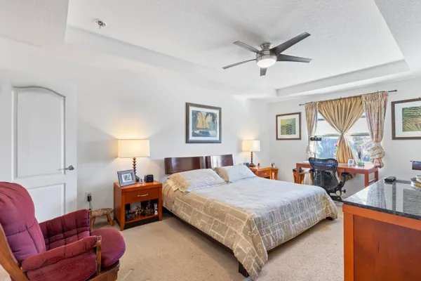 a bedroom with a bed couch and window