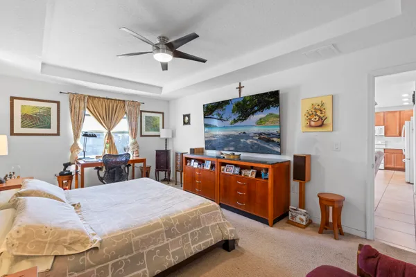 a bedroom with a bed and a flat screen tv