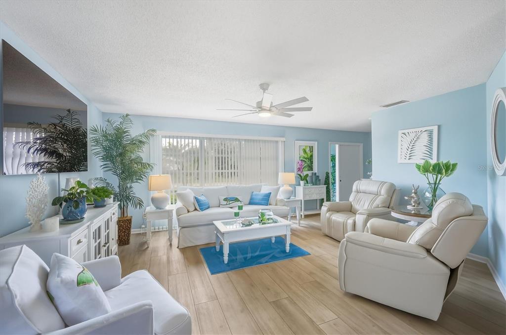 12577 Southwest Kings Row Lake Suzy, FL 34269 - Photo 12 of 56 a living room with furniture and a large window