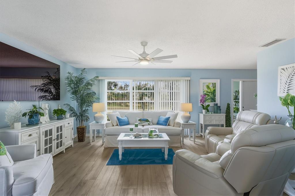12577 Southwest Kings Row Lake Suzy, FL 34269 - Photo 13 of 56 a living room with furniture and a large window