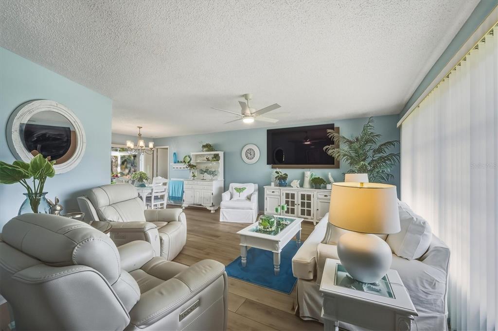 12577 Southwest Kings Row Lake Suzy, FL 34269 - Photo 14 of 56 a living room with furniture and a large window