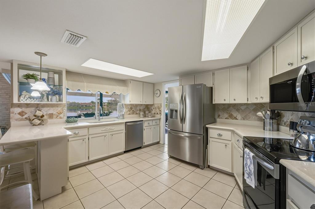 12577 Southwest Kings Row Lake Suzy, FL 34269 - Photo 20 of 56 a kitchen with a sink appliances and cabinets