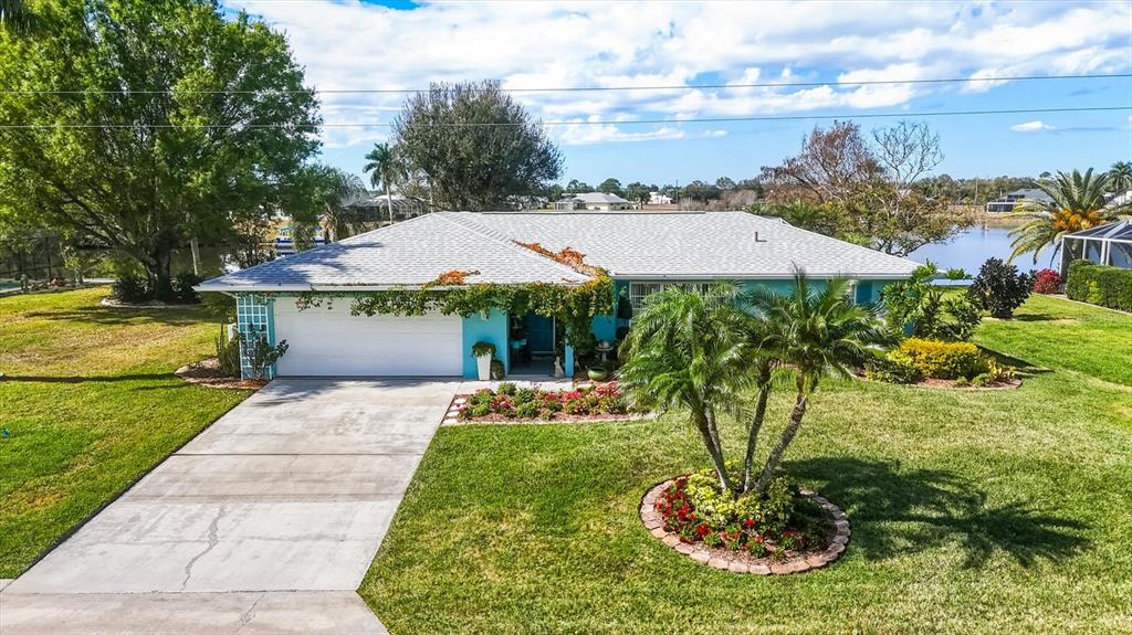 12577 Southwest Kings Row Lake Suzy, FL 34269 - Photo 2 of 56 a aerial view of a house with a yard basket ball court and outdoor seating