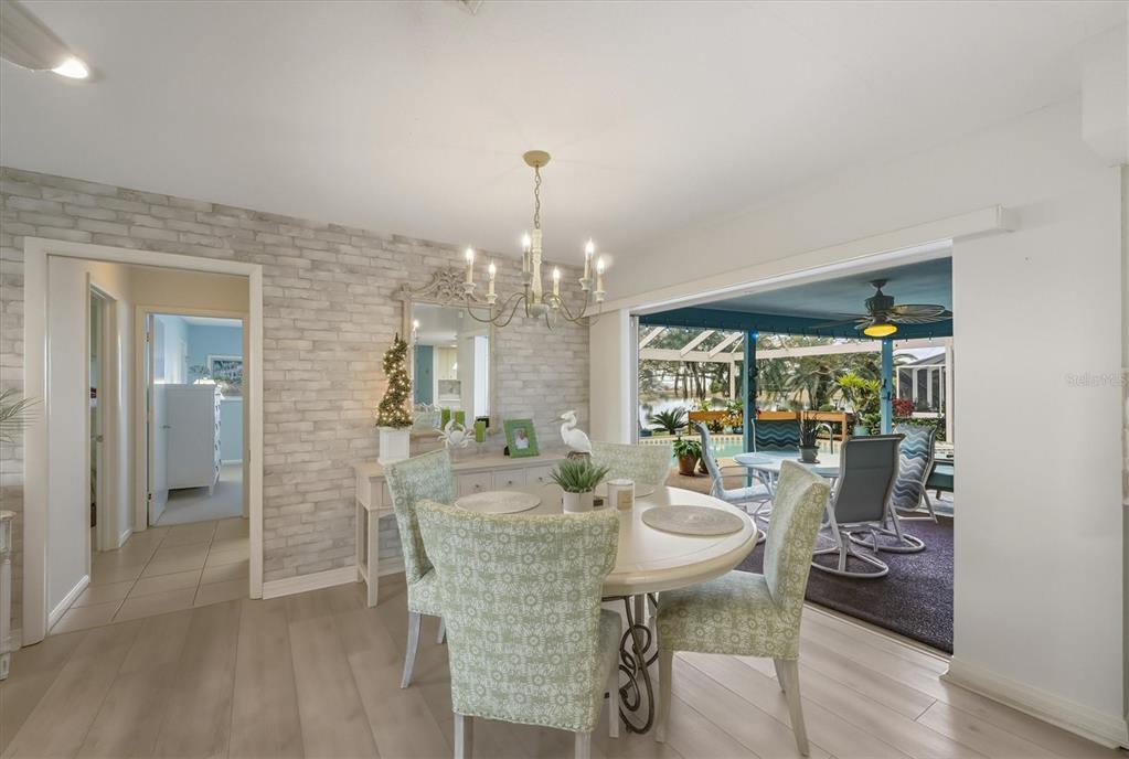 12577 Southwest Kings Row Lake Suzy, FL 34269 - Photo 22 of 56 a view of a dining room with furniture and chandelier