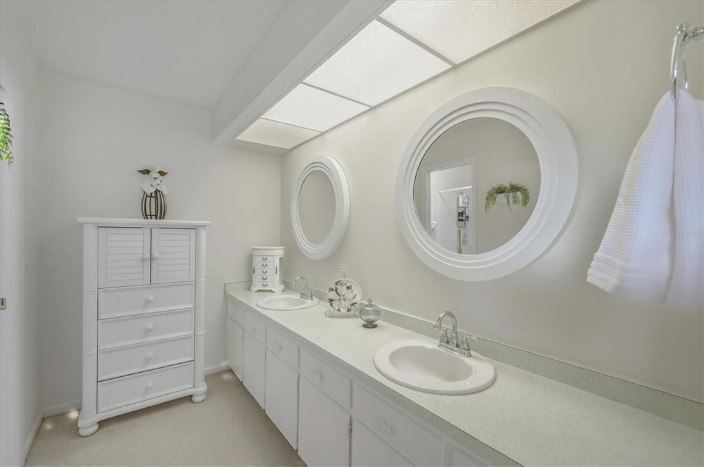 12577 Southwest Kings Row Lake Suzy, FL 34269 - Photo 27 of 56 a bathroom with a granite countertop sink and a mirror