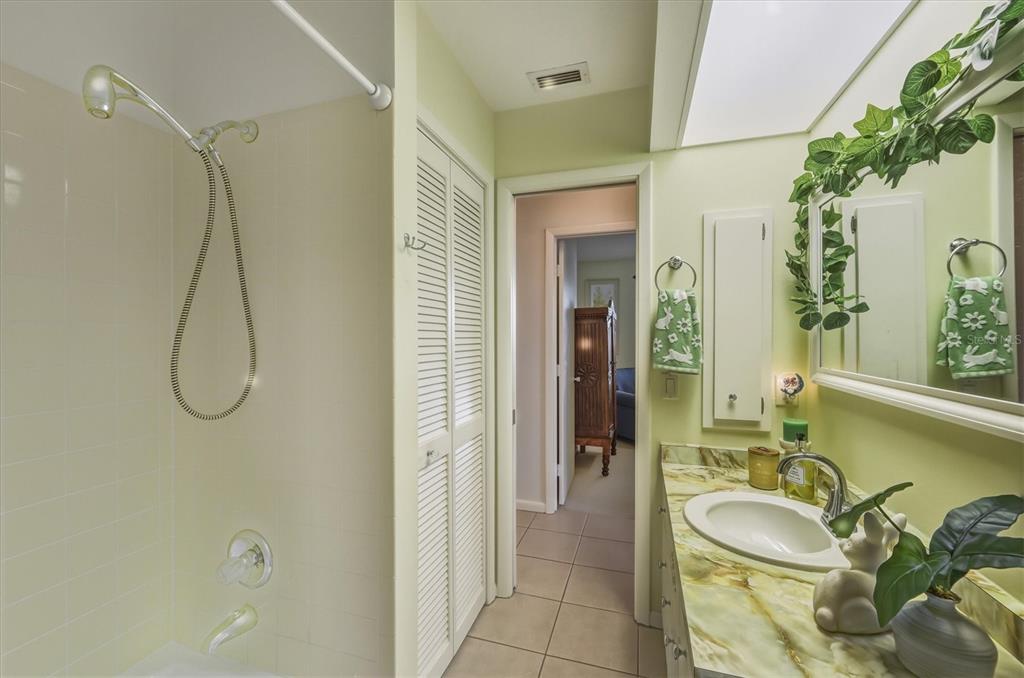 12577 Southwest Kings Row Lake Suzy, FL 34269 - Photo 31 of 56 a bathroom with a granite countertop sink a mirror and a shower