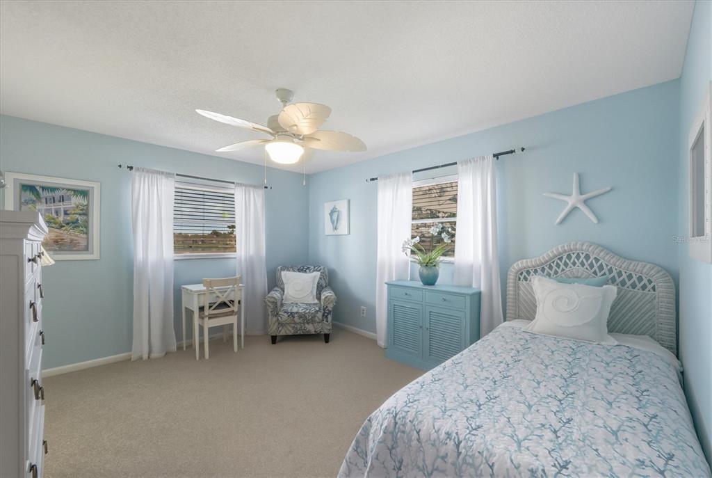 12577 Southwest Kings Row Lake Suzy, FL 34269 - Photo 32 of 56 a bedroom with a bed and a window
