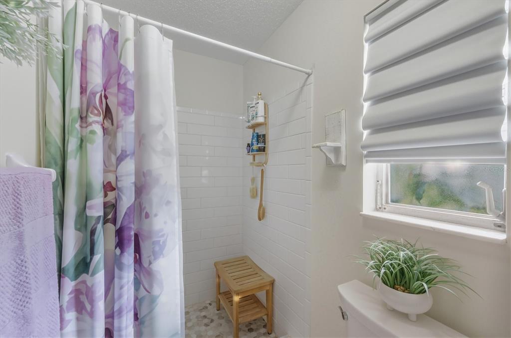 12577 Southwest Kings Row Lake Suzy, FL 34269 - Photo 33 of 56 a bathroom with a shower curtain
