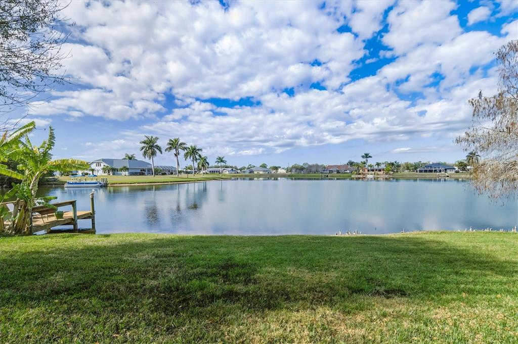 12577 Southwest Kings Row Lake Suzy, FL 34269 - Photo 41 of 56 a view of a lake from a yard
