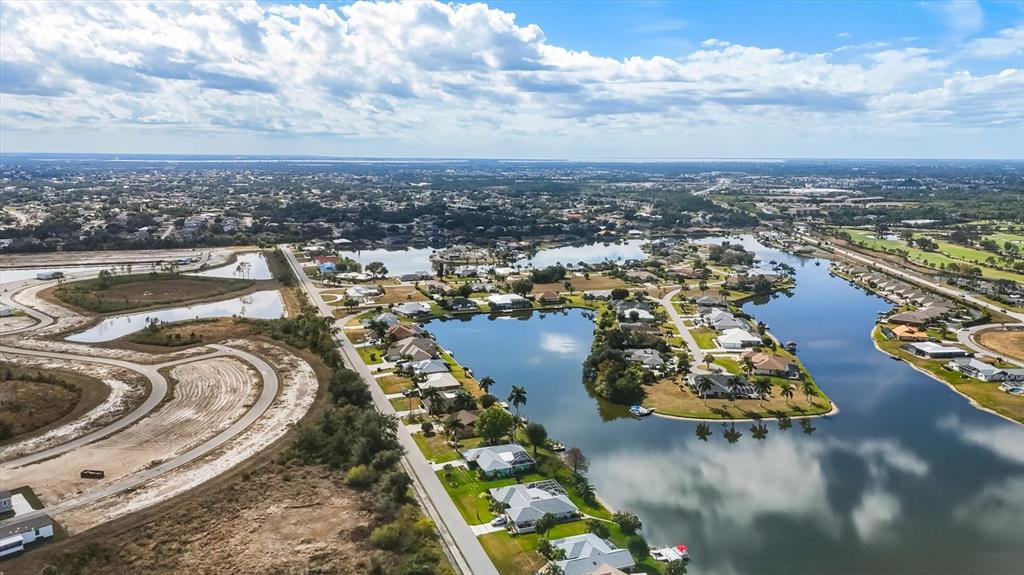 12577 Southwest Kings Row Lake Suzy, FL 34269 - Photo 51 of 56 an aerial view of a house with swimming pool and ocean view