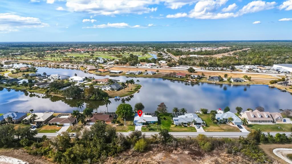 12577 Southwest Kings Row Lake Suzy, FL 34269 - Photo 54 of 56 an aerial view of a city with lots of residential buildings ocean and mountain view in back