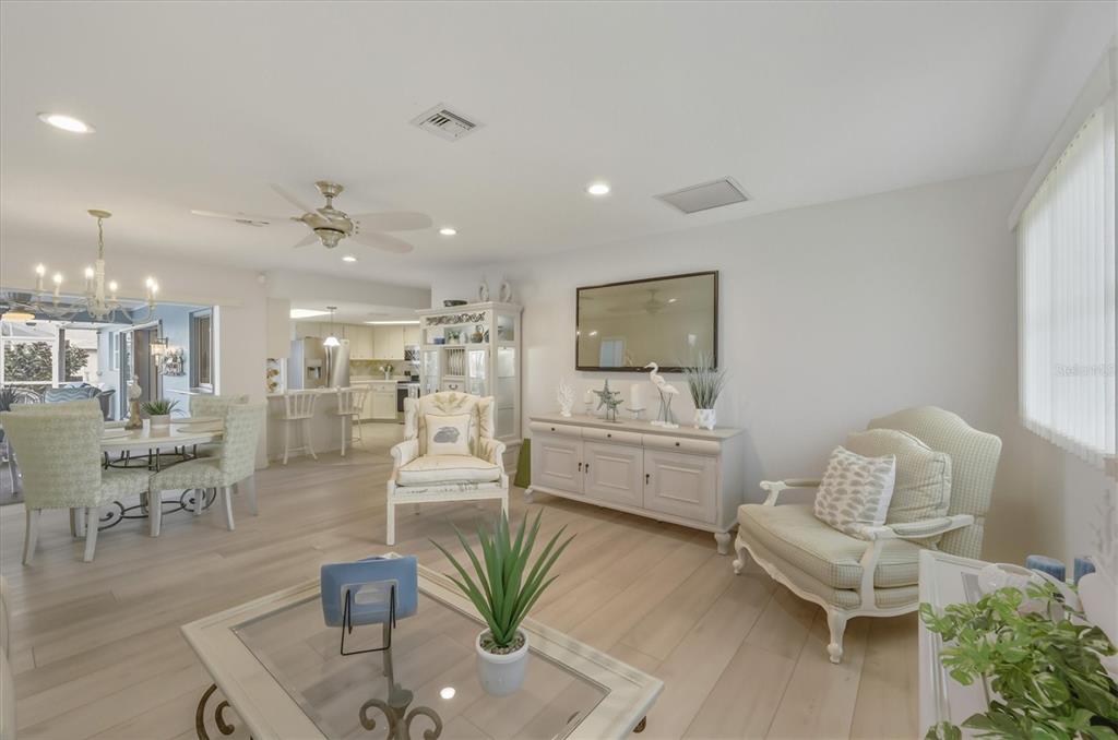 12577 Southwest Kings Row Lake Suzy, FL 34269 - Photo 10 of 56 a living room with furniture and a flat screen tv
