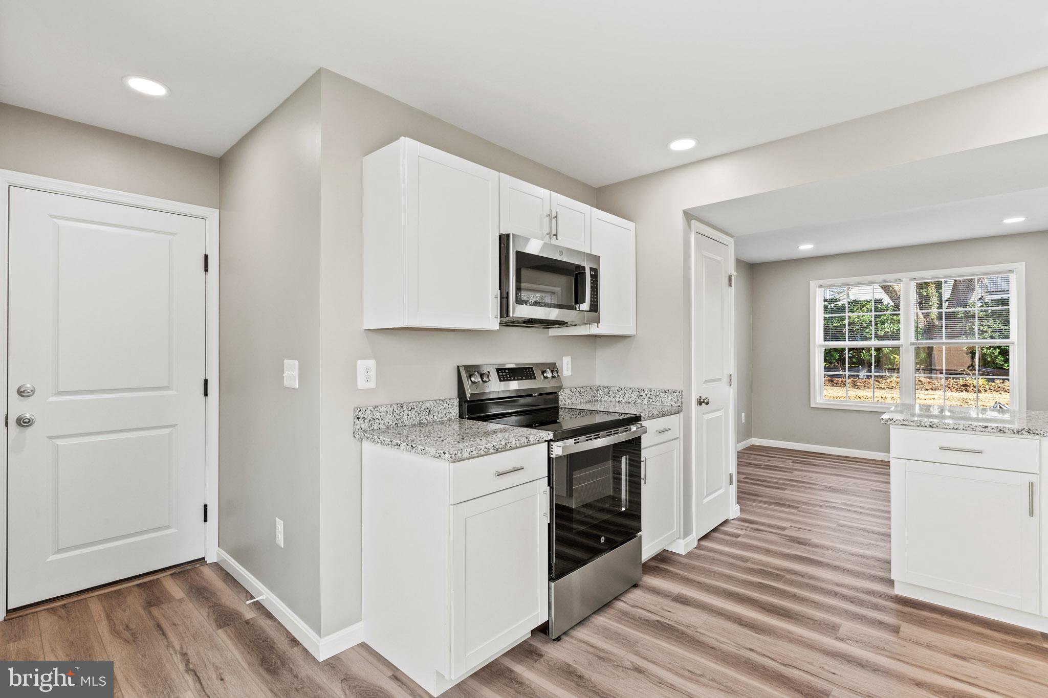 41577 Church Street Leonardtown, MD 20650 - Photo 11 of 25 a kitchen with a stove a sink and a microwave