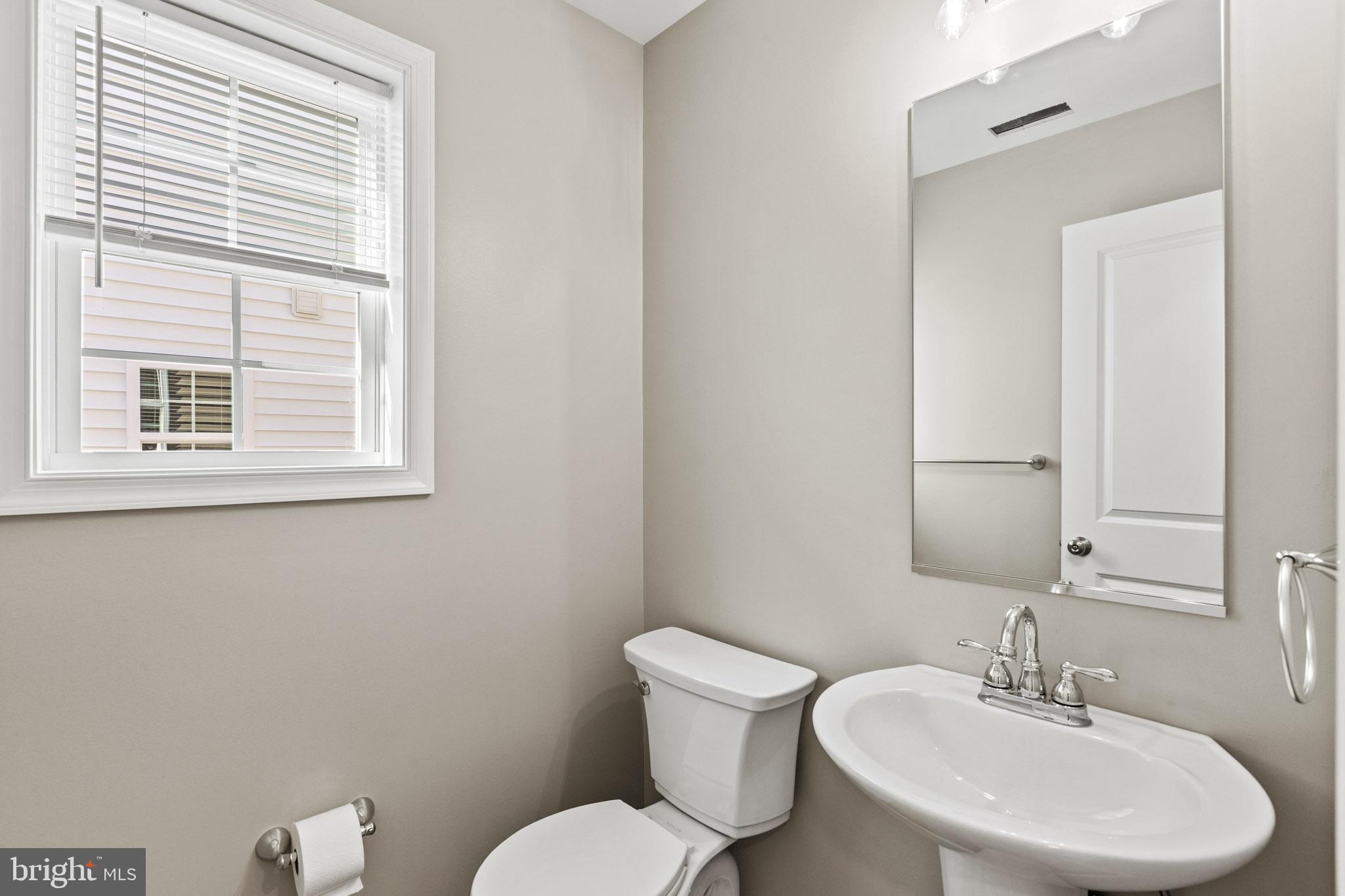 41577 Church Street Leonardtown, MD 20650 - Photo 12 of 25 a bathroom with a toilet a sink and a mirror