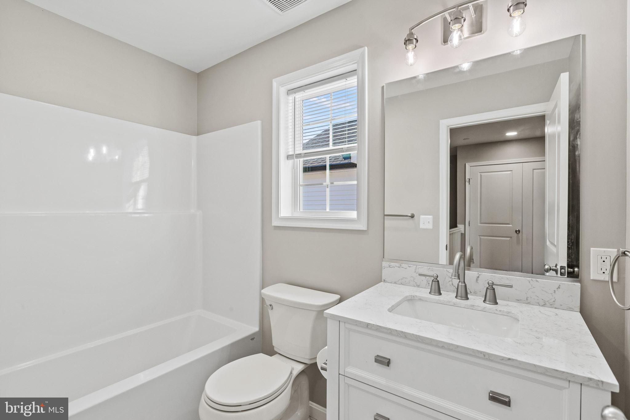 41577 Church Street Leonardtown, MD 20650 - Photo 14 of 25 a bathroom with a sink a toilet and shower