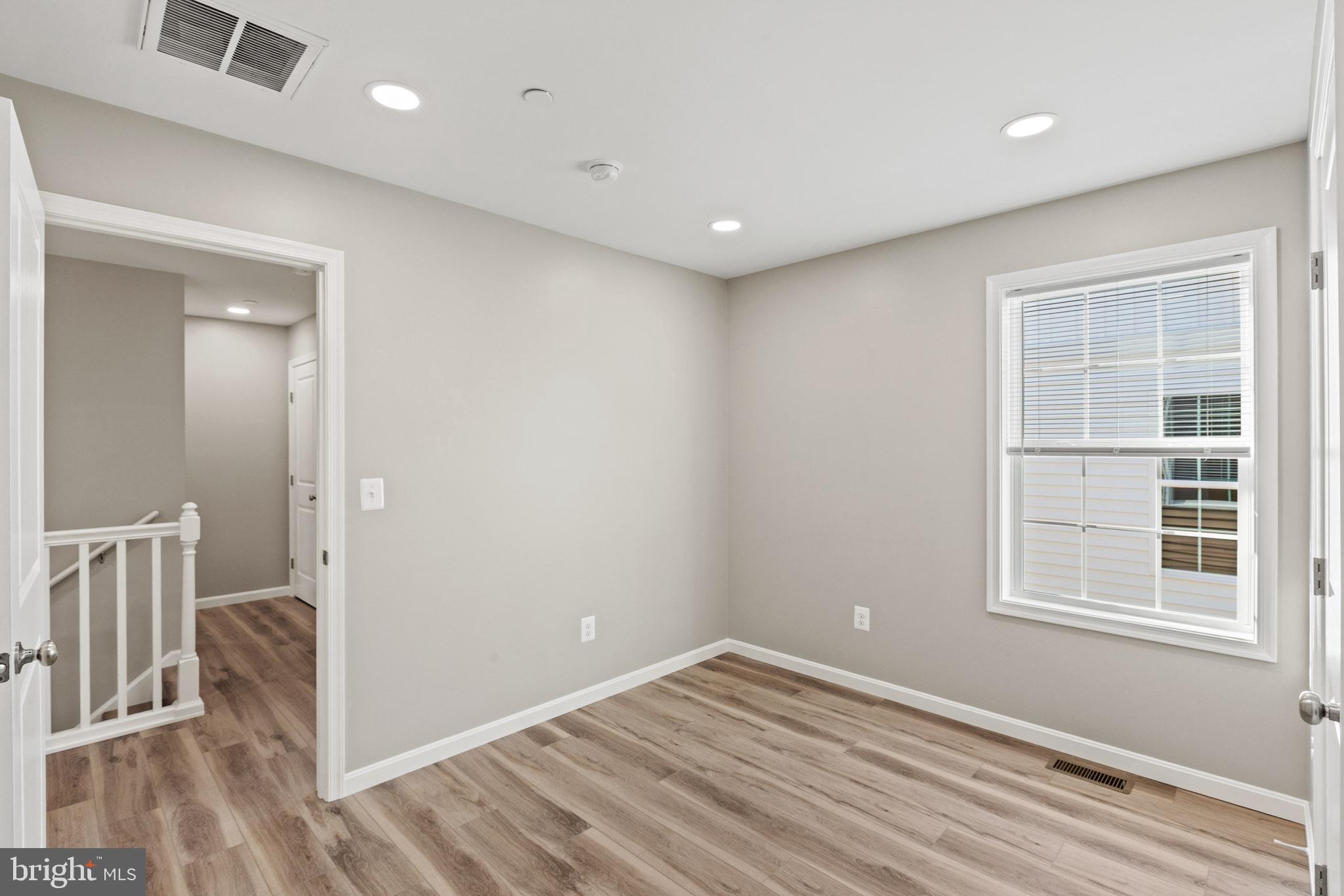 41577 Church Street Leonardtown, MD 20650 - Photo 16 of 25 a view of empty room with wooden floor and fan