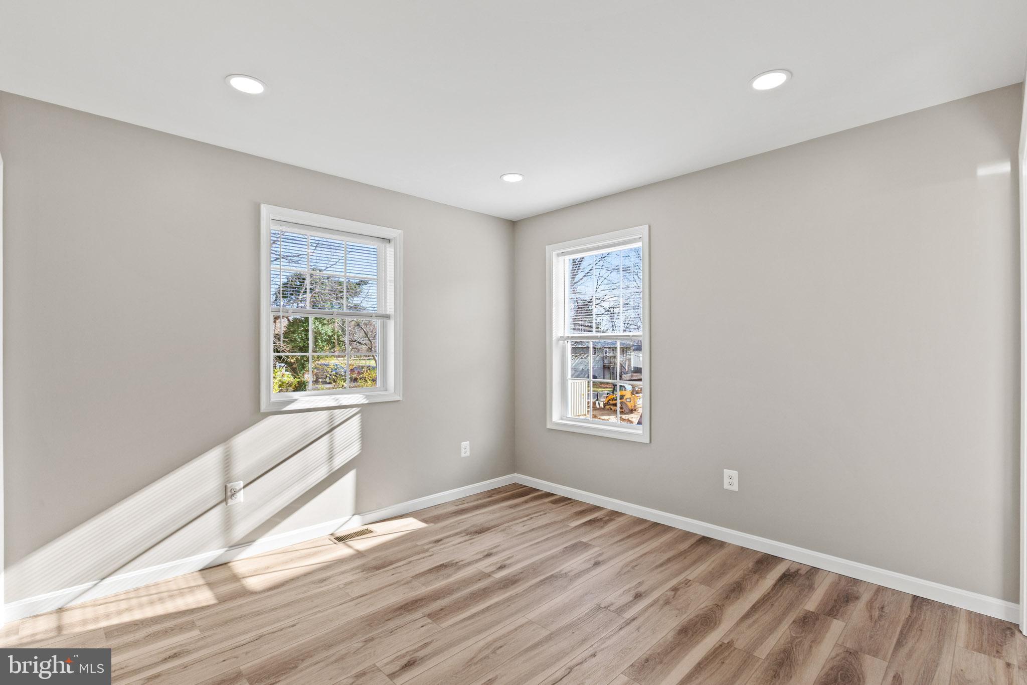 41577 Church Street Leonardtown, MD 20650 - Photo 20 of 25 an empty room with wooden floor and windows