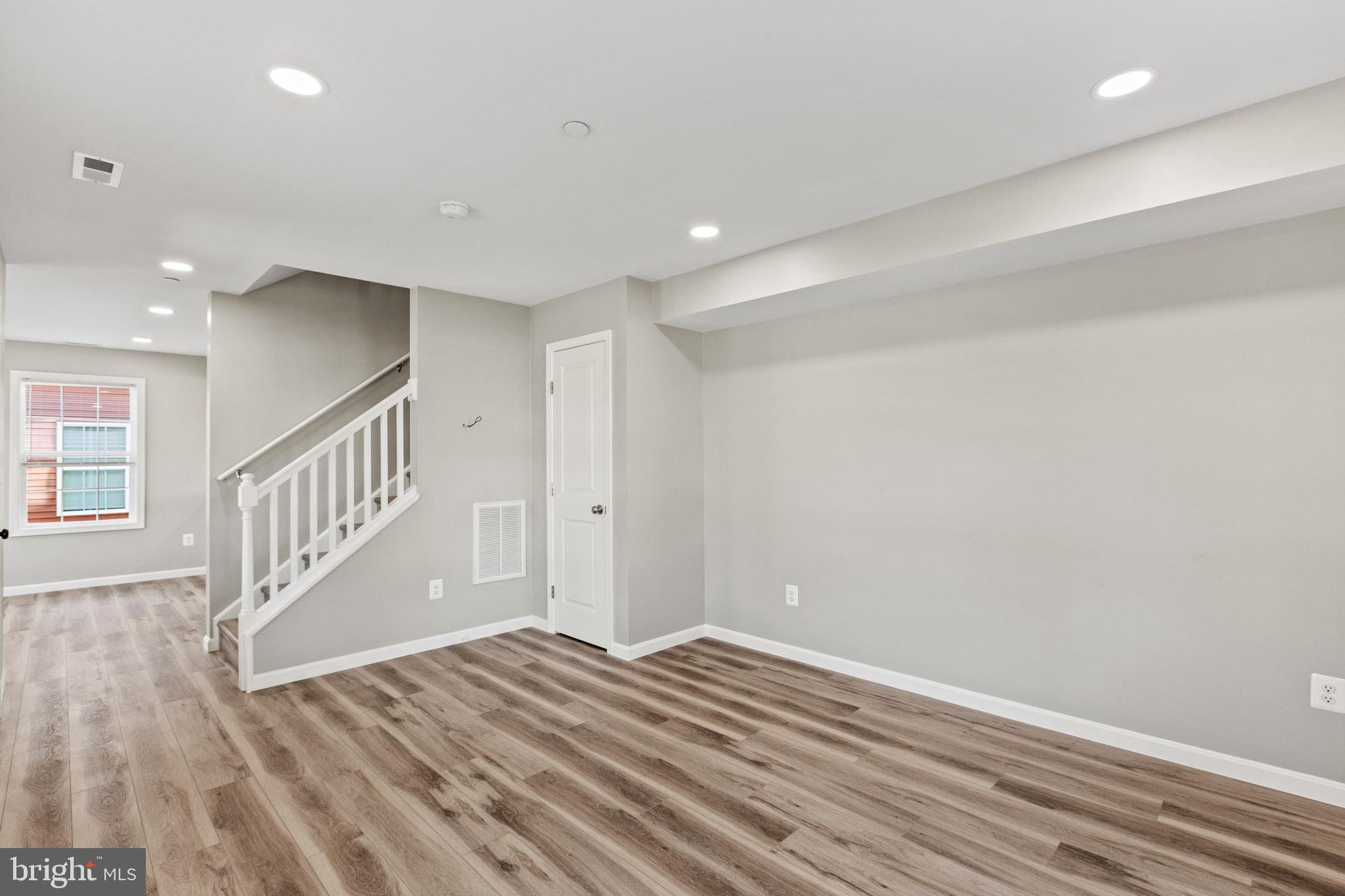 41577 Church Street Leonardtown, MD 20650 - Photo 6 of 25 a view of a hallway with wooden floor and staircase