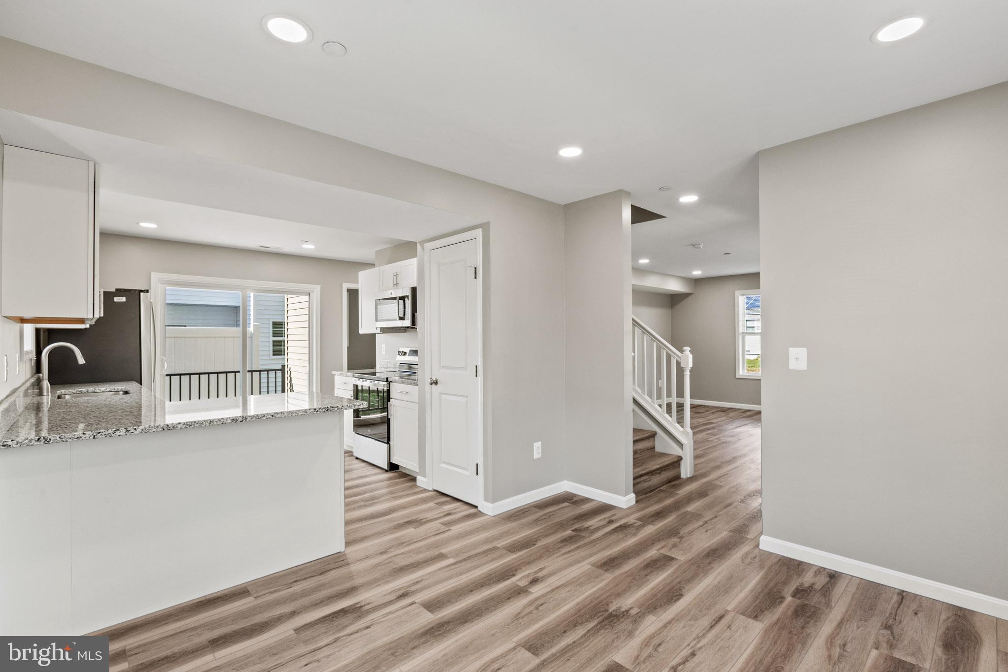 41577 Church Street Leonardtown, MD 20650 - Photo 9 of 25 a kitchen with stainless steel appliances granite countertop a refrigerator and a sink
