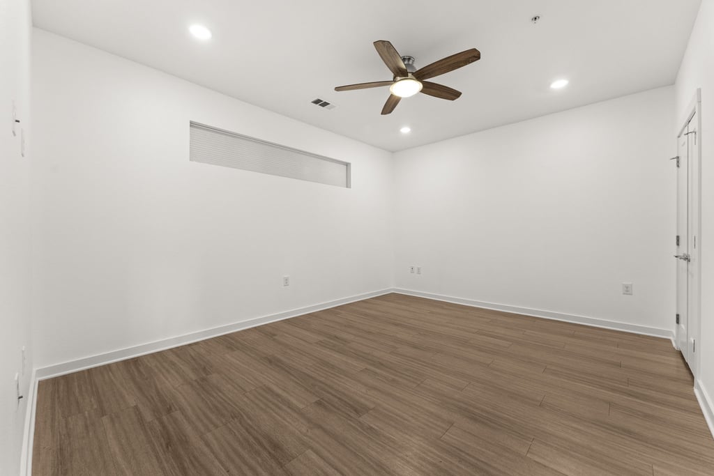 4361 South Congress Avenue, Unit 514 Austin, TX 78745 - Photo 12 of 28 an empty room with wooden floor and windows