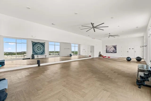 a view of a livingroom with a ceiling fan and window