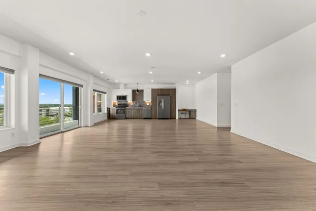 a view of a livingroom with furniture and floor to ceiling window