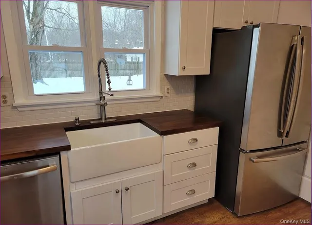 a kitchen with a refrigerator and a sink