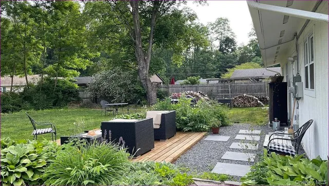 a view of a house with backyard sitting area and garden