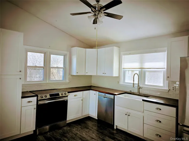 a kitchen with a sink stove and window