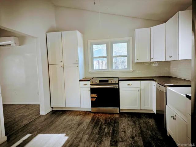 a kitchen with granite countertop a refrigerator and a stove