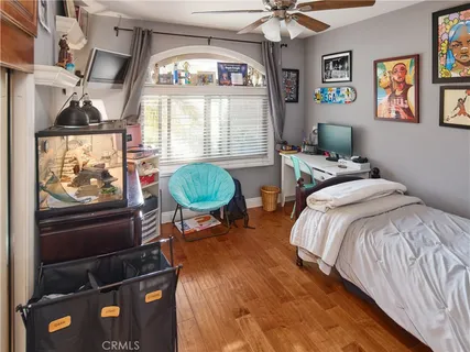 a bedroom with bed tv and window