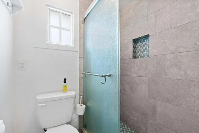 a white toilet sitting next to a bathroom sink