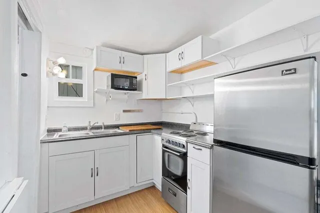 a kitchen with a sink and a stove top oven
