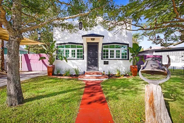 a front view of a house with garden and patio